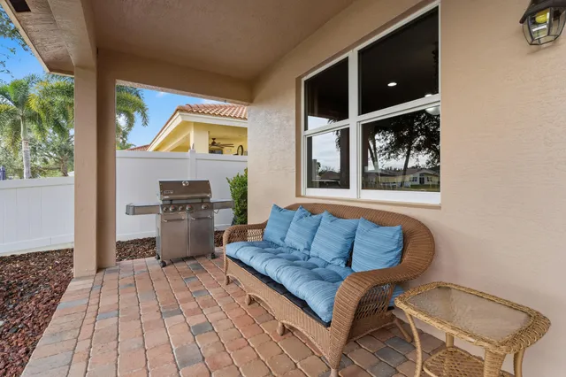 a living room with a couch and a stove next to a window