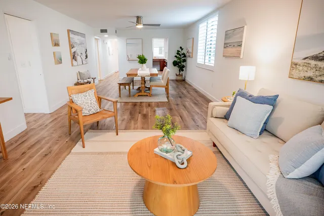 a living room with furniture and wooden floor
