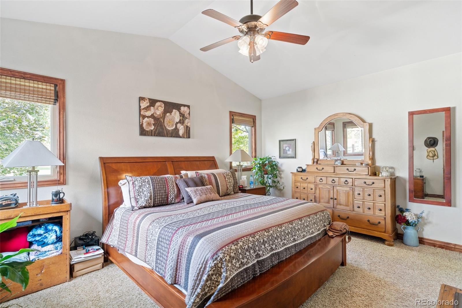 1731 Wales Drive Berthoud, CO 80513 - Photo 14 of 36 a bedroom with a bed and a chandelier