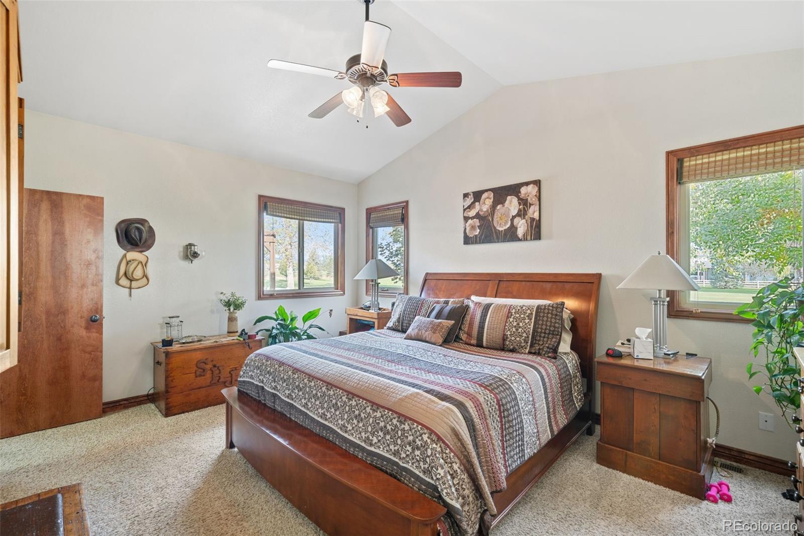 1731 Wales Drive Berthoud, CO 80513 - Photo 15 of 36 a bedroom with a large bed and a chandelier