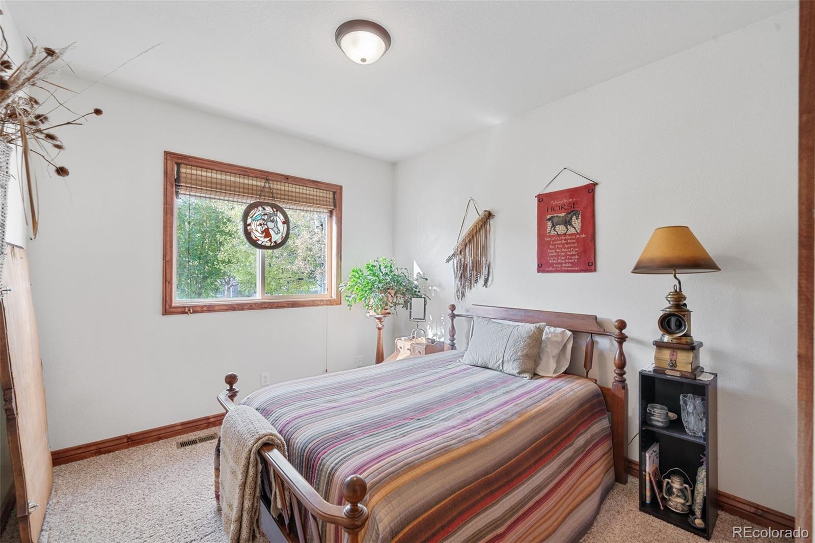 1731 Wales Drive Berthoud, CO 80513 - Photo 19 of 36 a bedroom with a bed and a painting on the wall