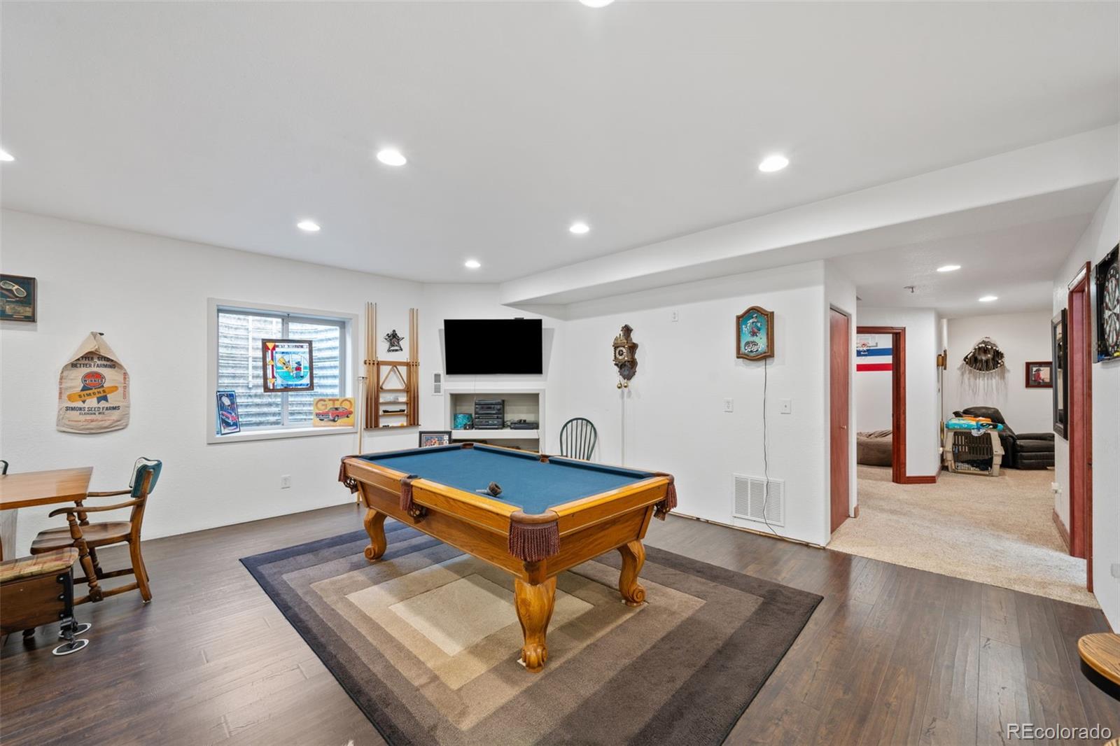 1731 Wales Drive Berthoud, CO 80513 - Photo 22 of 36 a living room with furniture and a flat screen tv
