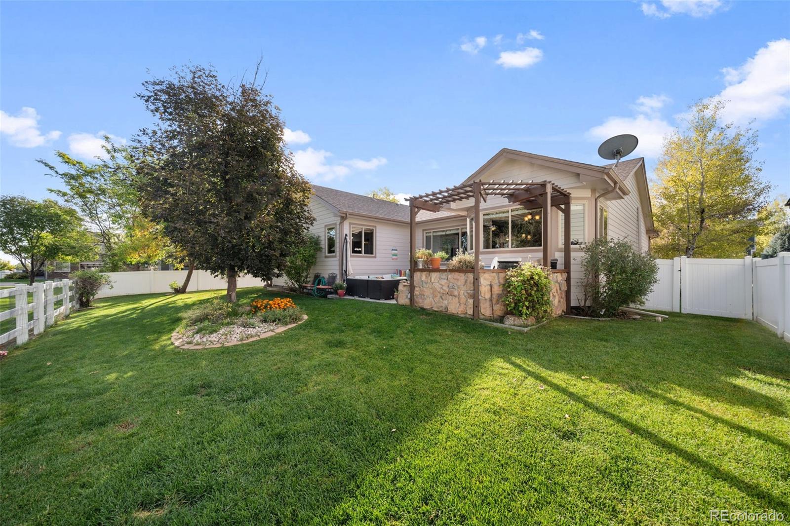 1731 Wales Drive Berthoud, CO 80513 - Photo 36 of 36 a front view of a house with a yard and trees