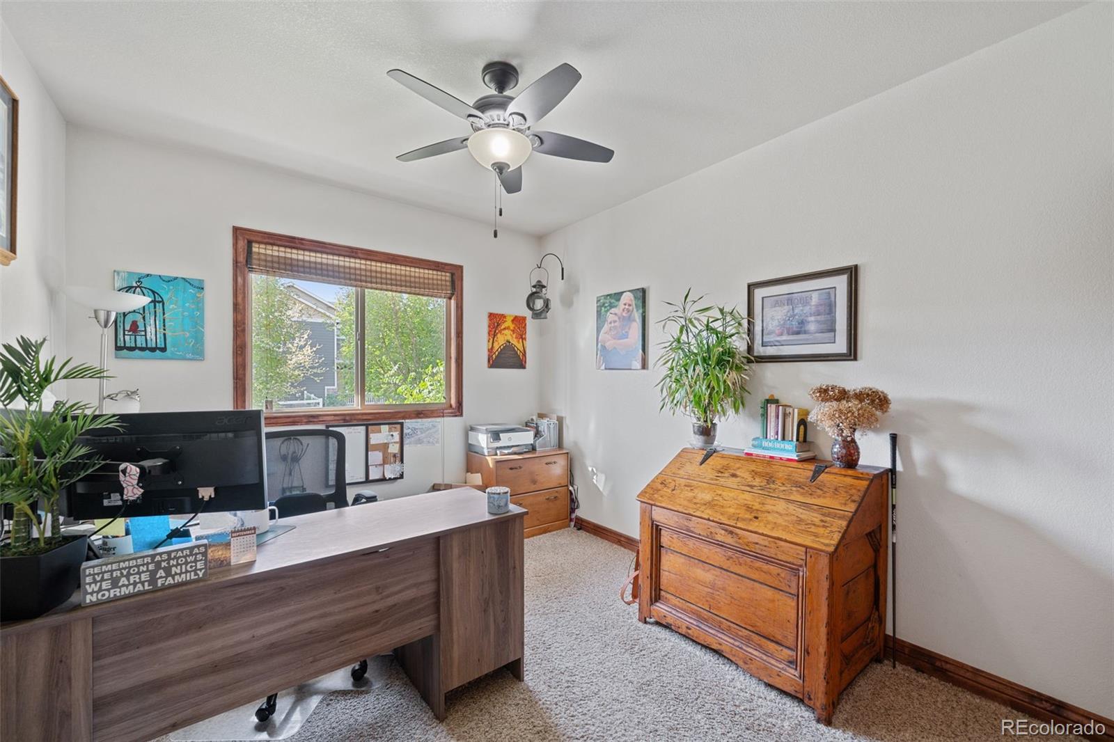 1731 Wales Drive Berthoud, CO 80513 - Photo 5 of 36 a bedroom with a bed and a chandelier