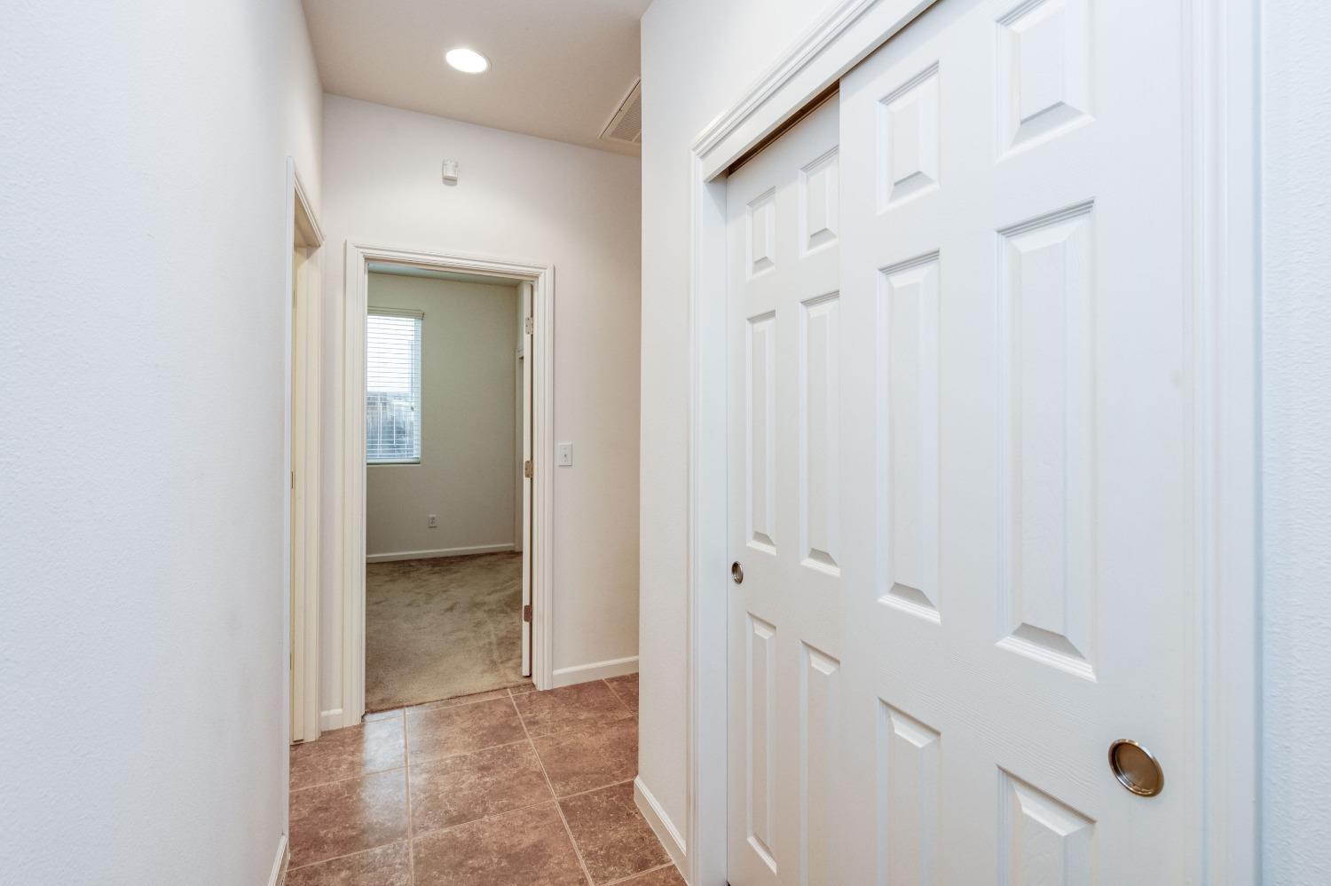 3994 Chessa Lane Clovis, CA 93619 - Photo 16 of 36 a view of a bathroom from a hallway