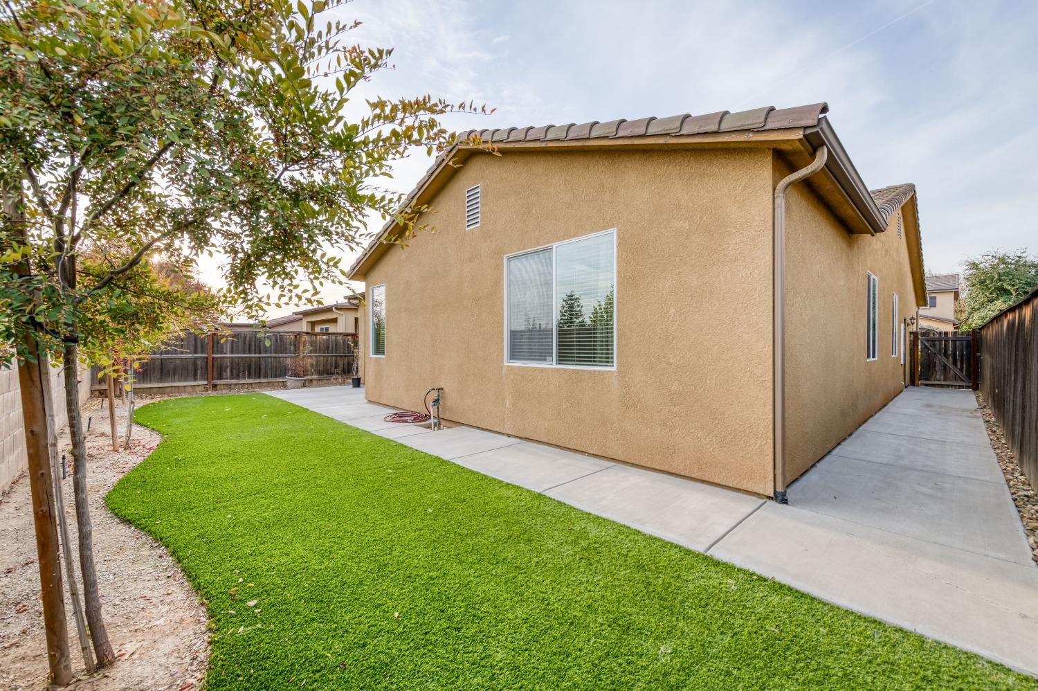 3994 Chessa Lane Clovis, CA 93619 - Photo 22 of 36 a view of an house with backyard space and garden