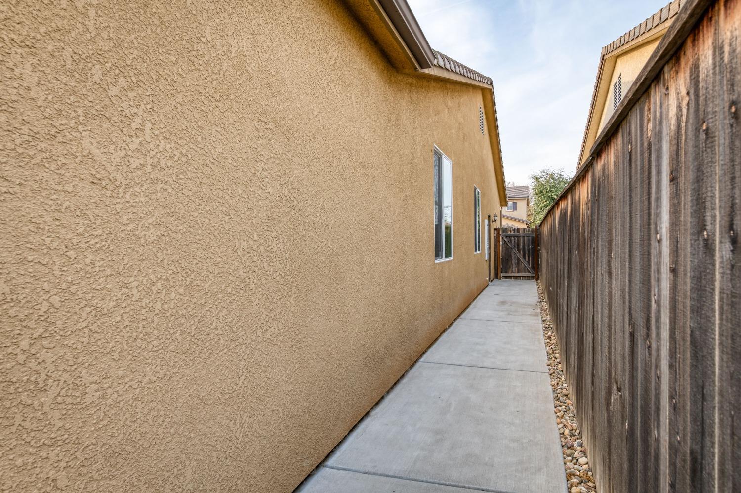 3994 Chessa Lane Clovis, CA 93619 - Photo 23 of 36 a view of a pathway with a building in the background