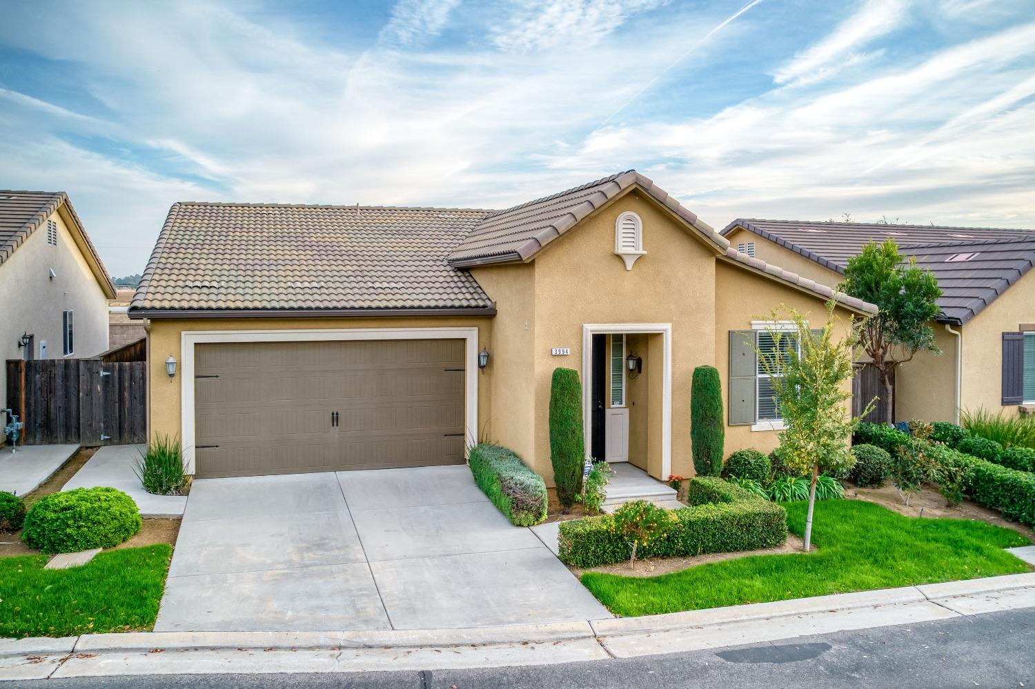 3994 Chessa Lane Clovis, CA 93619 - Photo 26 of 36 a front view of house with garage and yard