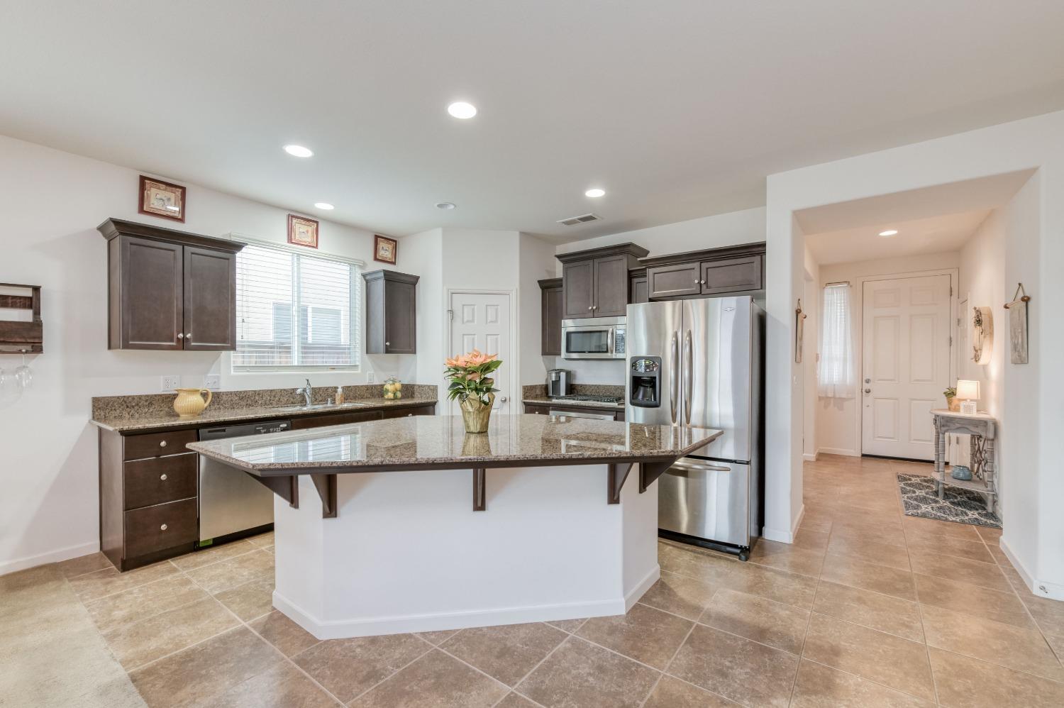 3994 Chessa Lane Clovis, CA 93619 - Photo 4 of 36 a kitchen with stainless steel appliances granite countertop a sink stove and refrigerator