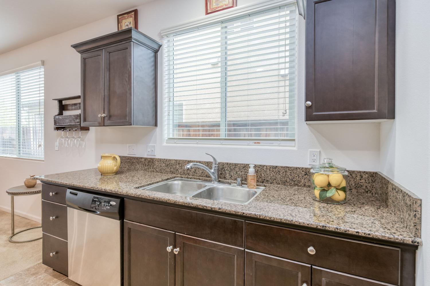 3994 Chessa Lane Clovis, CA 93619 - Photo 7 of 36 a kitchen with granite countertop a sink and a window