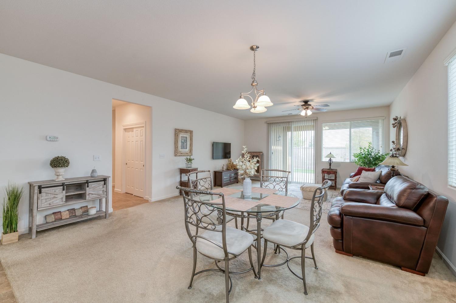 3994 Chessa Lane Clovis, CA 93619 - Photo 8 of 36 a view of a livingroom with furniture window and wooden floor
