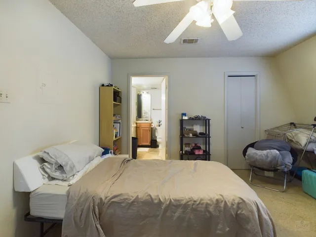 a bedroom with a bed and a large mirror