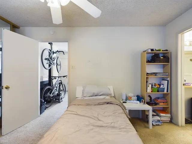 a bedroom with bed and a chandelier
