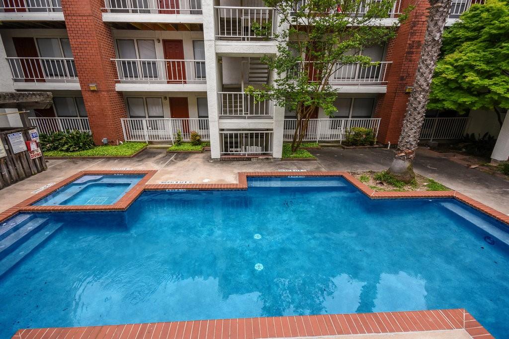 3115 Helms Street, Unit 301 Austin, TX 78705 - Photo 16 of 19 a swimming pool with outdoor seating and yard