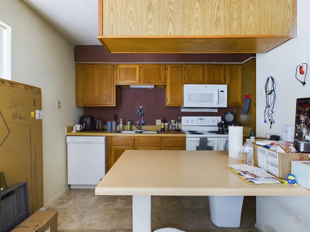 3115 Helms Street, Unit 301 Austin, TX 78705 - Photo 3 of 19 a kitchen with stainless steel appliances a stove a sink and a refrigerator