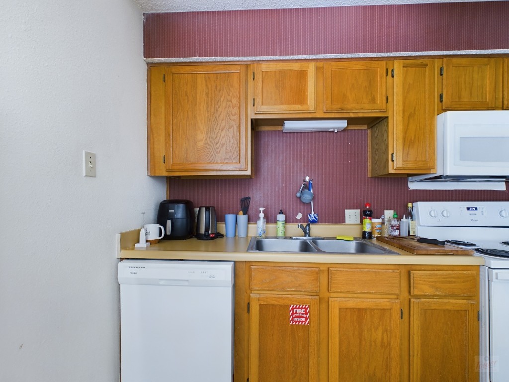 3115 Helms Street, Unit 301 Austin, TX 78705 - Photo 4 of 19 a kitchen with sink cabinets and utility