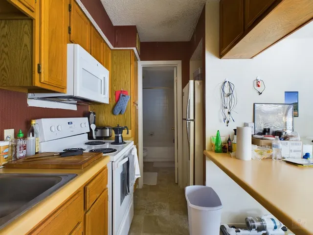 a kitchen that has a sink and a stove in it