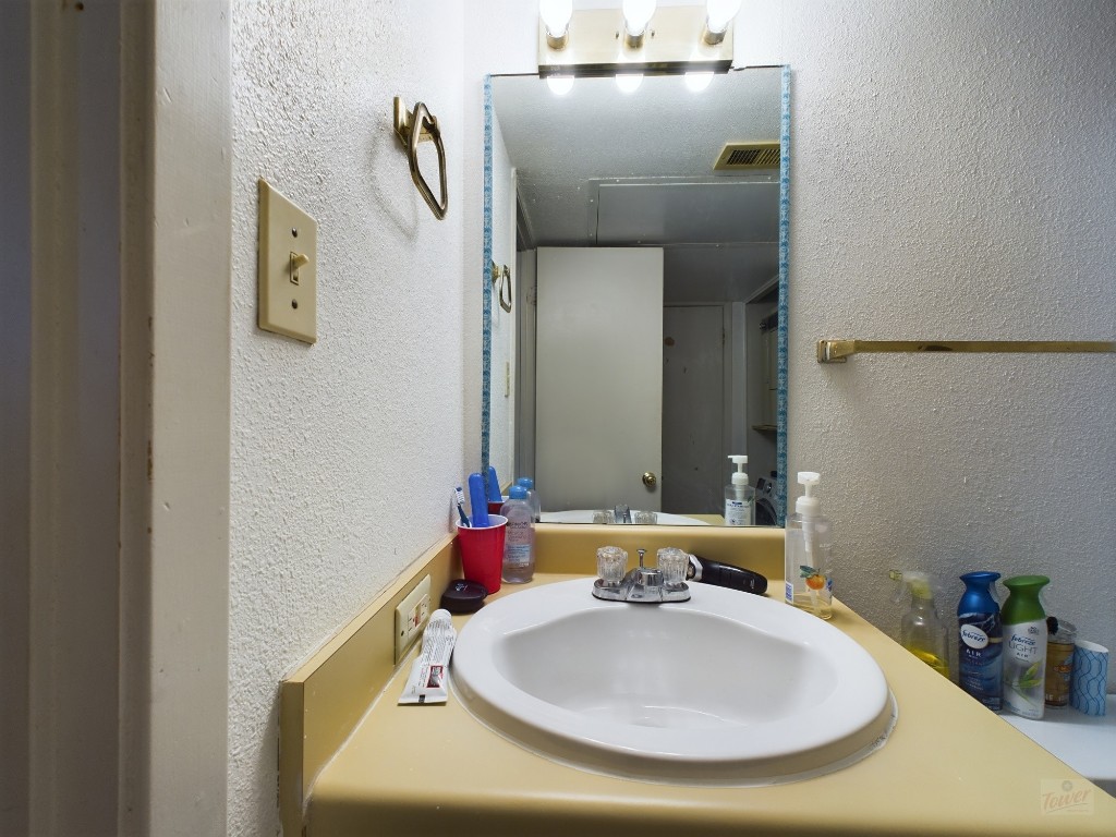 3115 Helms Street, Unit 301 Austin, TX 78705 - Photo 8 of 19 a bathroom with a sink and mirror