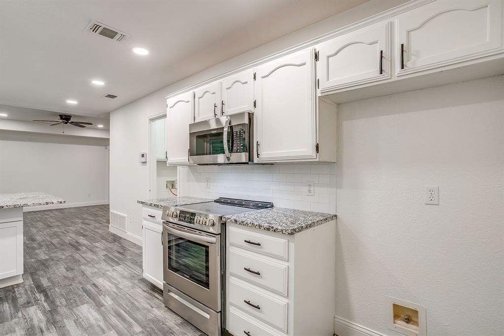 155 Ann Court Azle, TX 76020 - Photo 14 of 39 Kitchen with stainless steel appliances, light stone counters, white cabinets, and recessed lighting