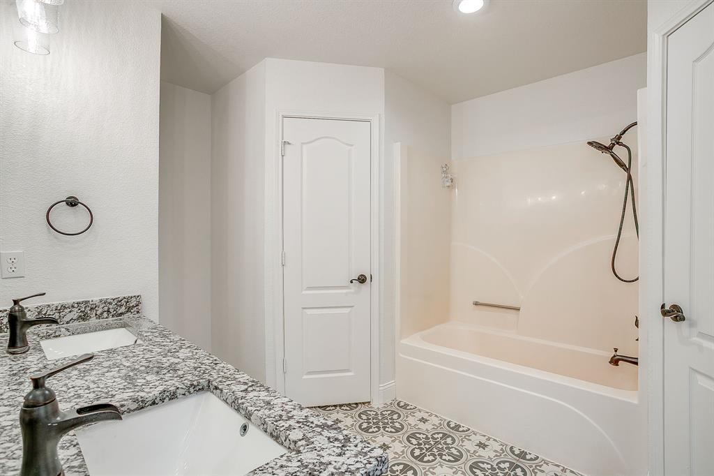 155 Ann Court Azle, TX 76020 - Photo 20 of 39 Full bathroom with double vanity, shower / bath combination, tile patterned floors, and recessed lighting