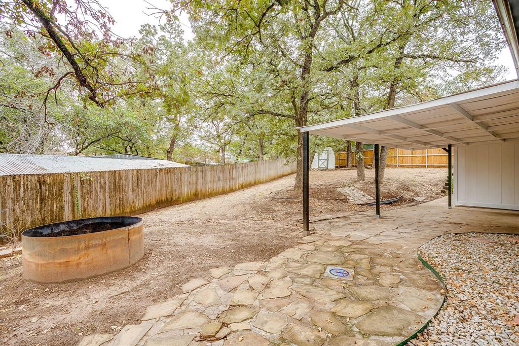 155 Ann Court Azle, TX 76020 - Photo 32 of 39 Fenced backyard with a patio area and a shed
