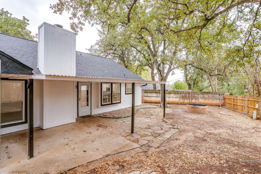 155 Ann Court Azle, TX 76020 - Photo 33 of 39 Fenced backyard with a patio area and a fire pit