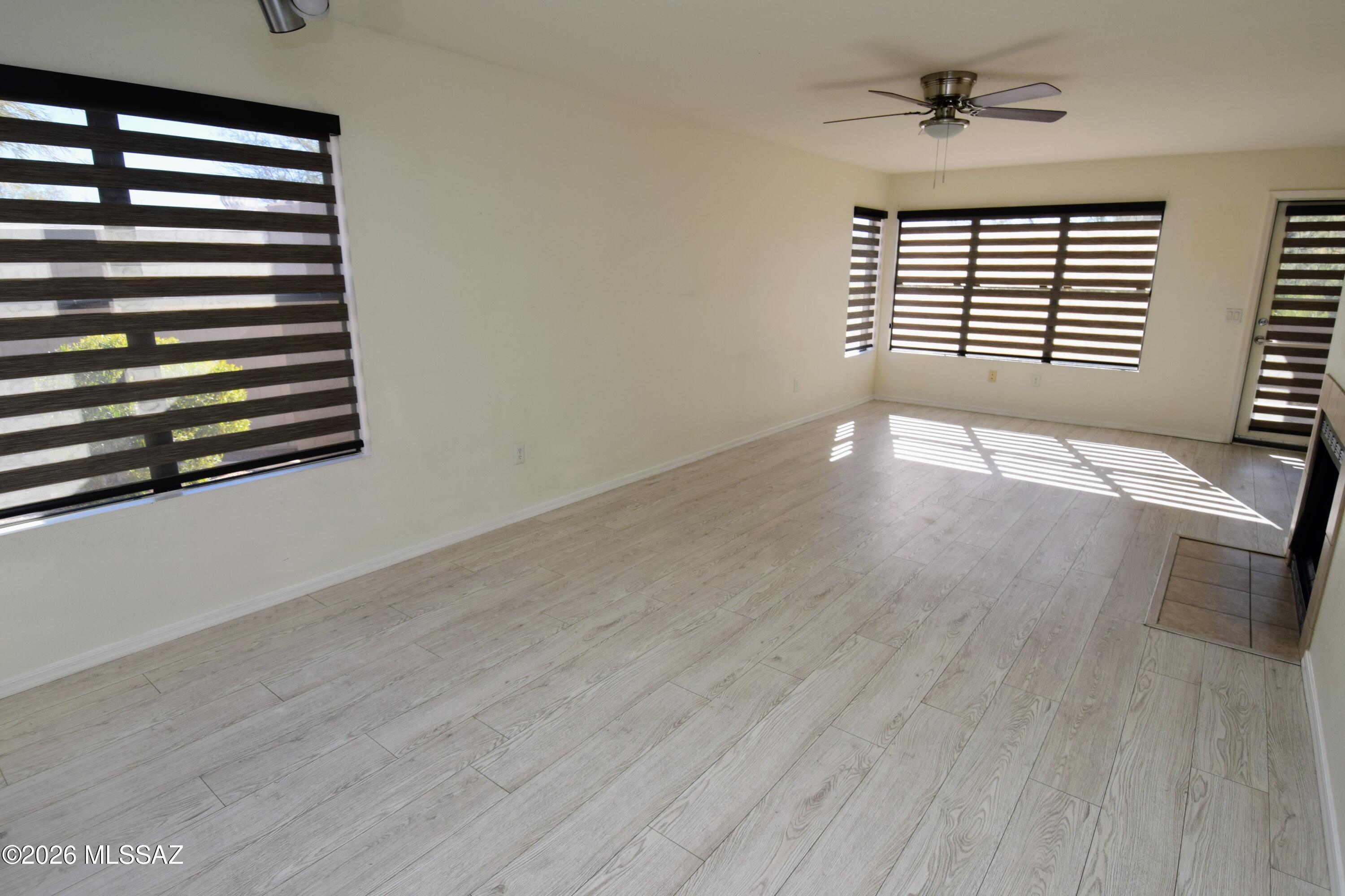 5855 North Kolb Road, Unit 11106 Tucson, AZ 85750 - Photo 3 of 36 a view of empty room with wooden floor and fan