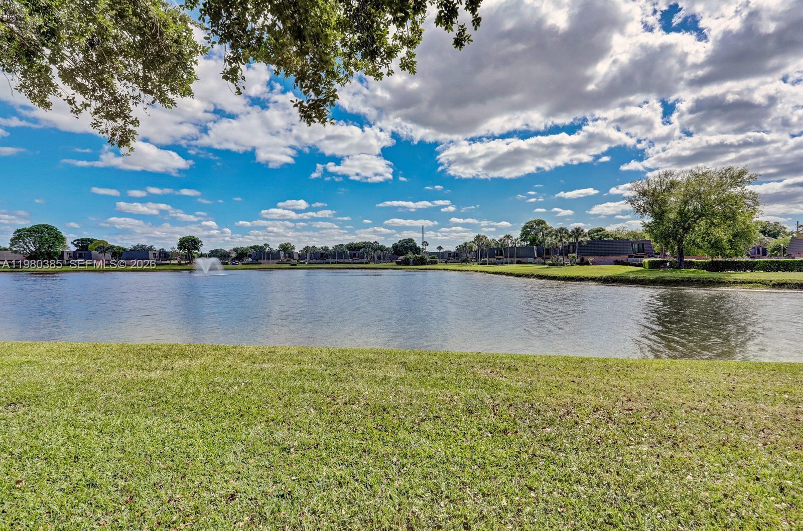 237 Charter Way, Unit 237 West Palm Beach, FL 33407 - Photo 15 of 18 a view of a lake with houses in the back