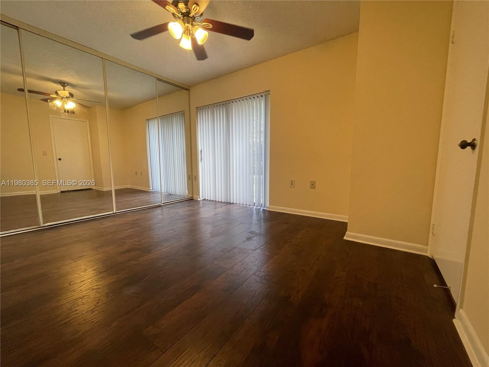 237 Charter Way, Unit 237 West Palm Beach, FL 33407 - Photo 7 of 18 a view of an empty room with wooden floor
