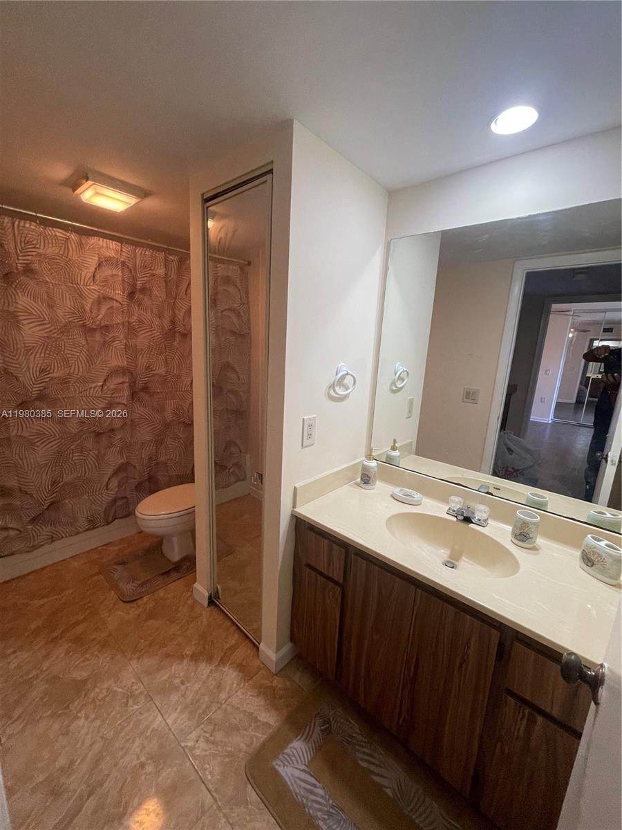 237 Charter Way, Unit 237 West Palm Beach, FL 33407 - Photo 8 of 18 a spacious bathroom with a double vanity sink toilet and a mirror