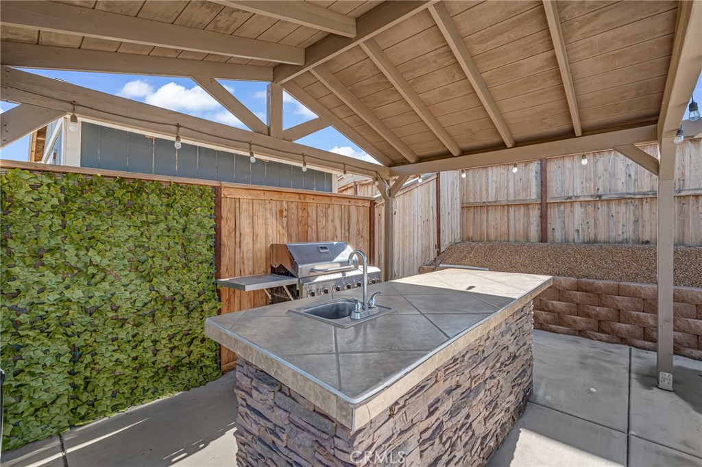 11409 Bellevue Street Adelanto, CA 92301 - Photo 16 of 49 a view of a backyard with table and chairs