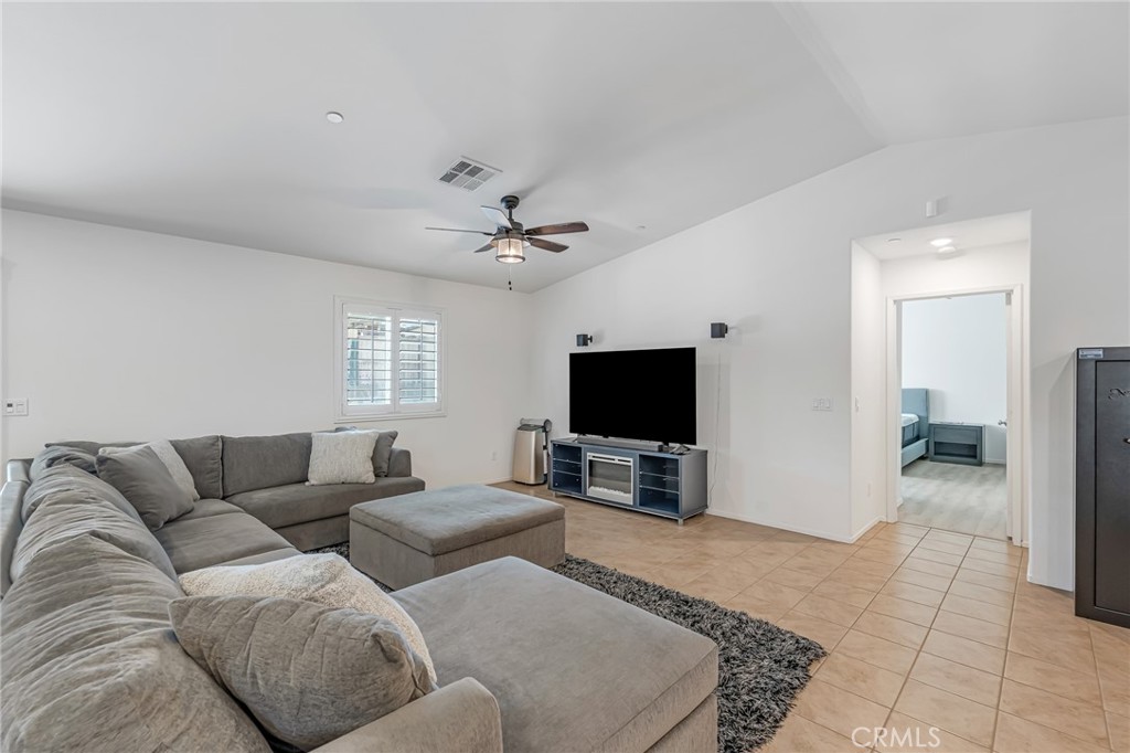 11409 Bellevue Street Adelanto, CA 92301 - Photo 30 of 49 a living room with furniture and a flat screen tv