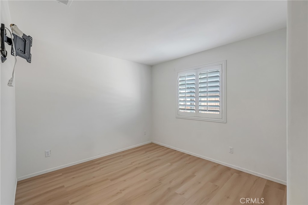 11409 Bellevue Street Adelanto, CA 92301 - Photo 38 of 49 wooden floor in an empty room with a window
