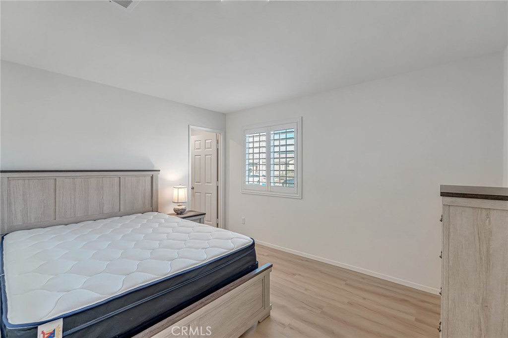 11409 Bellevue Street Adelanto, CA 92301 - Photo 46 of 49 a bedroom with a bed and a window