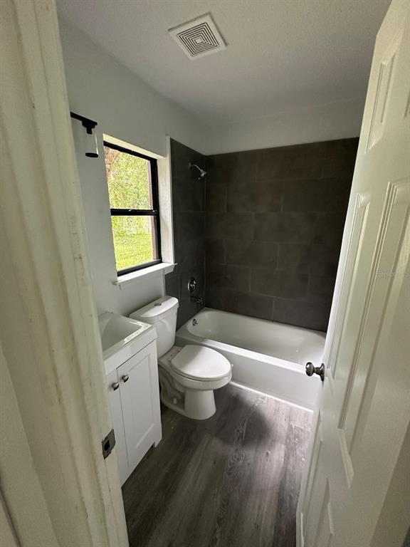 4514 Arch Street Orlando, FL 32808 - Photo 11 of 21 a bathroom with a toilet a sink and a bathtub