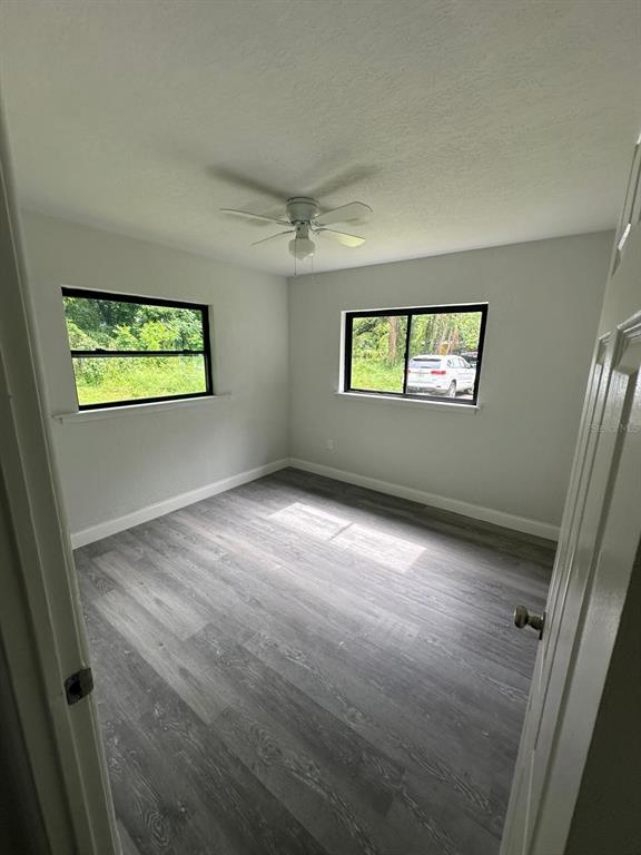 4514 Arch Street Orlando, FL 32808 - Photo 13 of 21 a view of room with hardwood floor and window