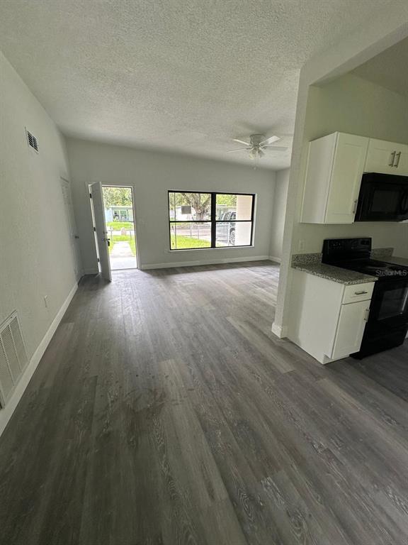 4514 Arch Street Orlando, FL 32808 - Photo 14 of 21 an empty room with wooden floor and windows