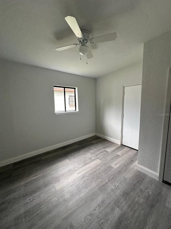 4514 Arch Street Orlando, FL 32808 - Photo 4 of 21 an empty room with a ceiling fan and window