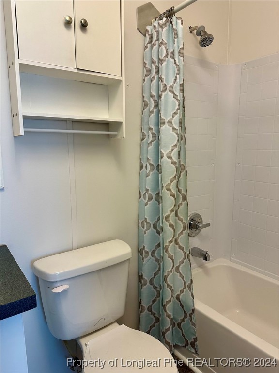 459 Nye Road Orrum, NC 28369 - Photo 13 of 25 a white toilet sitting next to a bath tub