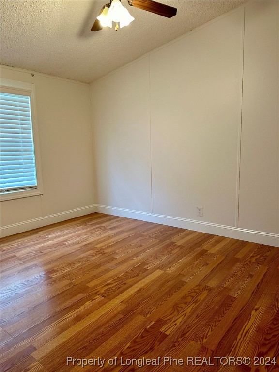 459 Nye Road Orrum, NC 28369 - Photo 16 of 25 an empty room with wooden floor and windows