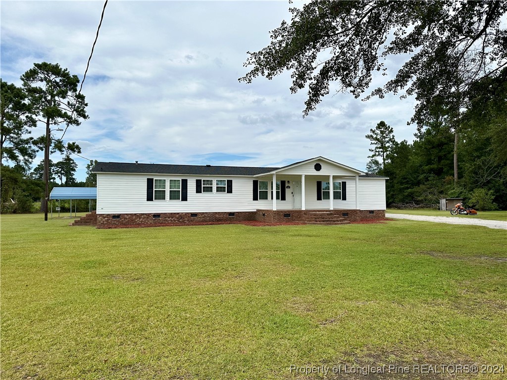 459 Nye Road Orrum, NC 28369 - Photo 2 of 25 a front view of a house with a garden