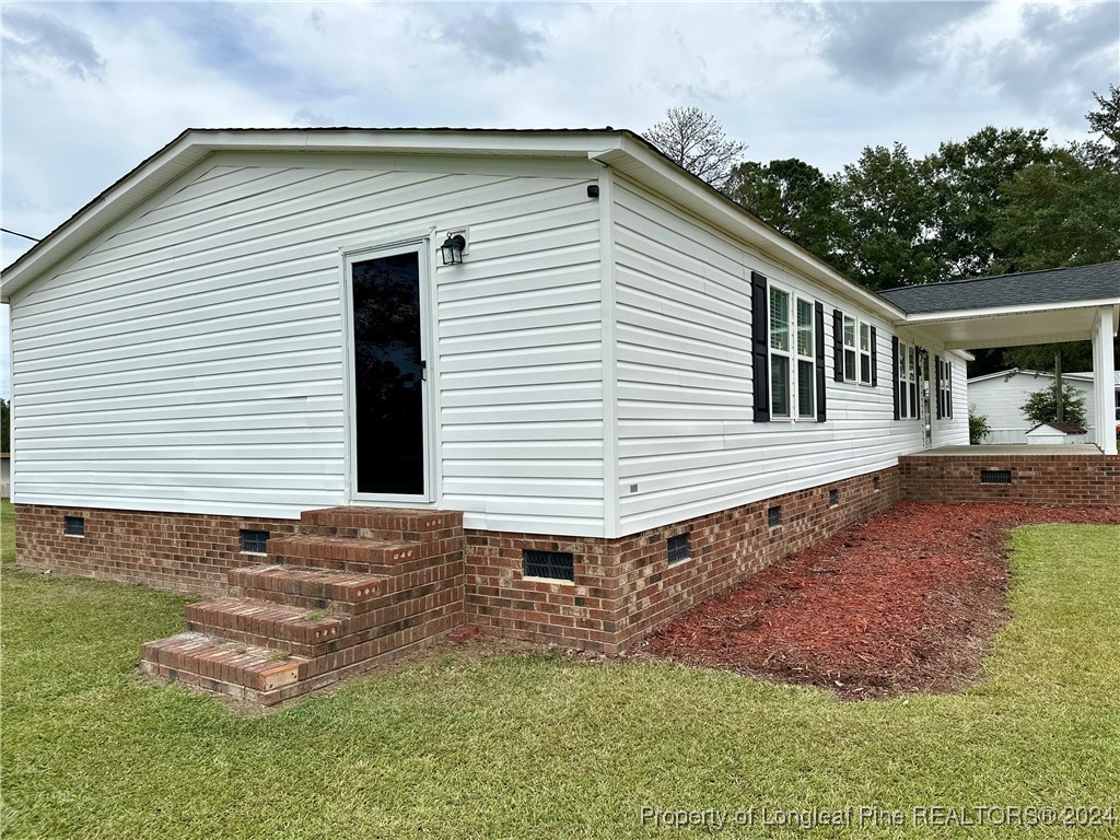 459 Nye Road Orrum, NC 28369 - Photo 3 of 25 a front view of a house with a yard