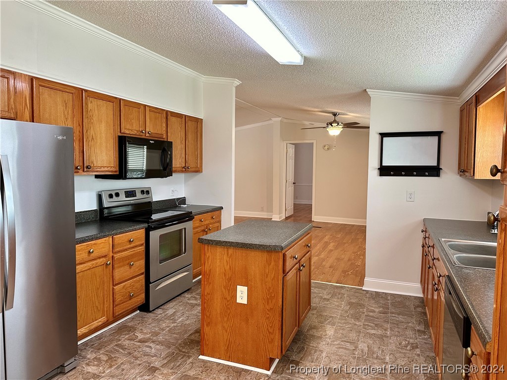 459 Nye Road Orrum, NC 28369 - Photo 9 of 25 a kitchen with stainless steel appliances granite countertop a refrigerator stove and sink