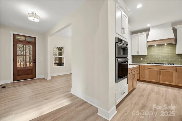 a kitchen with stainless steel appliances a stove a sink and a refrigerator