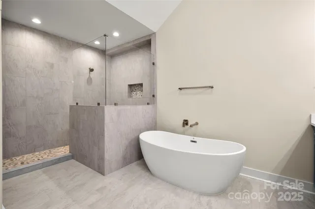 a spacious bathroom with a bathtub and shower