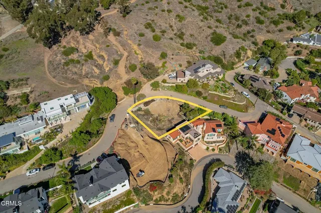 an aerial view of a house with a backyard