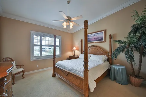 a bed room with a bed and a potted plant