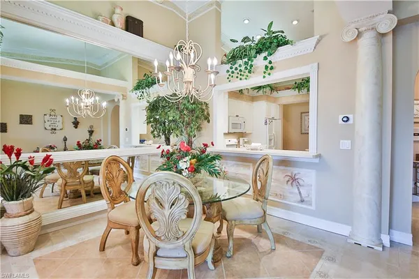 a view of a dining room with furniture and a chandelier