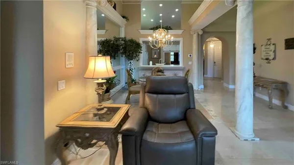 a dining room with furniture and a chandelier