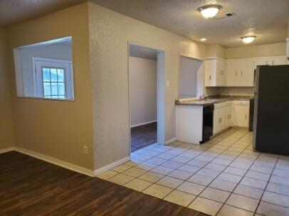6123 35th Street Lubbock, TX 79407 - Photo 3 of 7 a view of kitchen with granite countertop cabinets and wooden floor